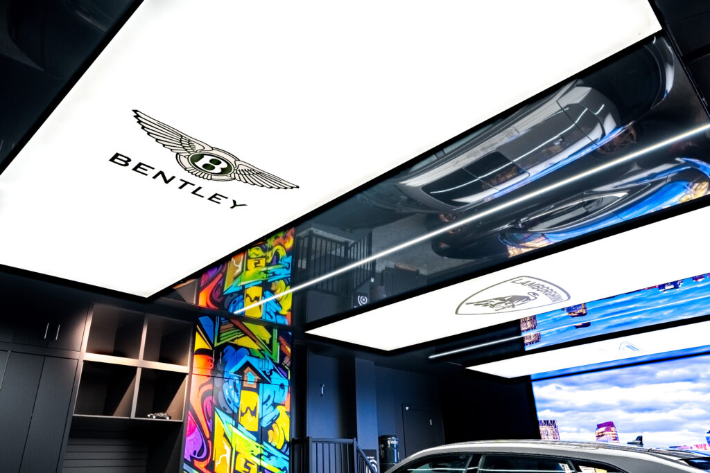 Luxury Bentley car displayed in a premium garage lounge with stretch ceiling and ambient lighting.