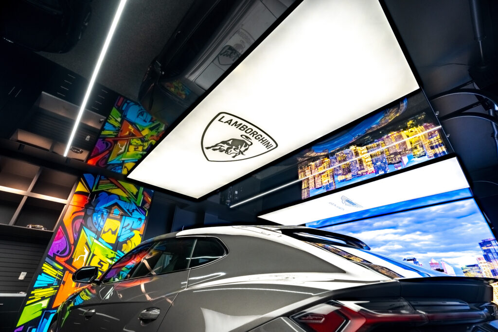 Lamborghini parked in a luxurious garage with stretch ceilings, ambient lighting, and modern finishes.