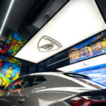 Lamborghini parked in a luxurious garage with stretch ceilings, ambient lighting, and modern finishes.